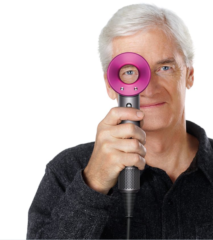 James Dyson holding the Dyson Supersoni™ hair dryer
